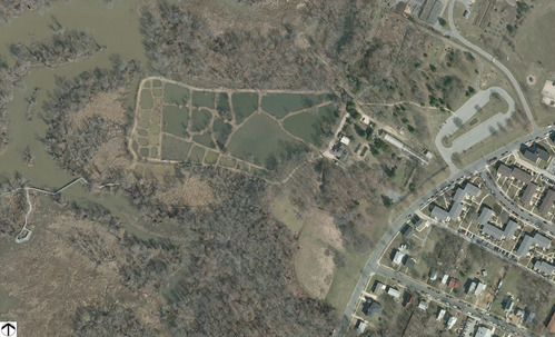 An aerial view shows the mosaic of ponds, surrounded by marsh and residential development.