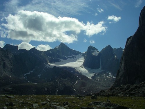 A glacier contrasts with the dark grey granite peaks of the Arrigetch.