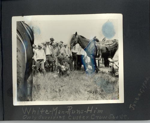 White Man Runs Him in Native Dress Surrounded by People and Horses