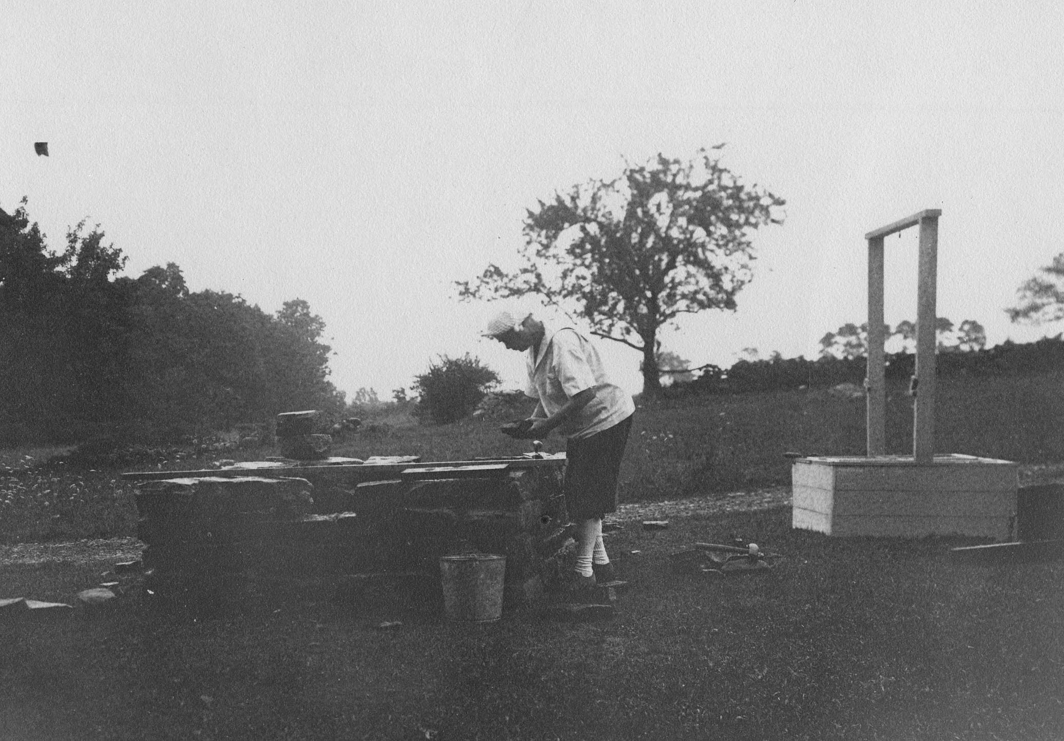 Black and white photo of a woman working outside