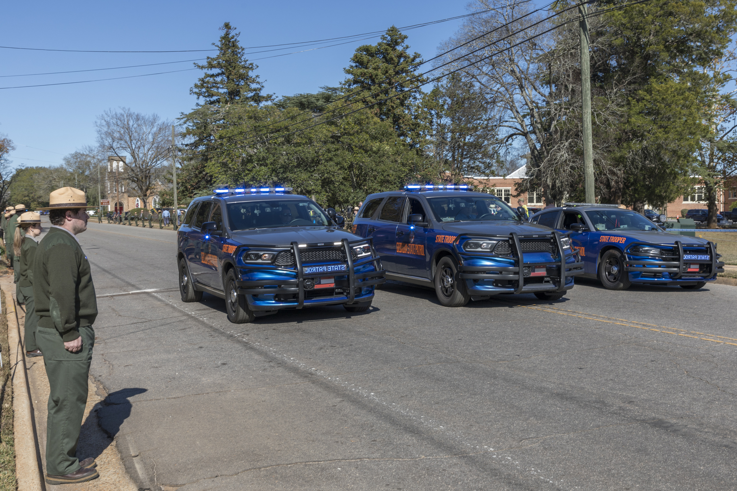 Three blue and grey police vehicles.