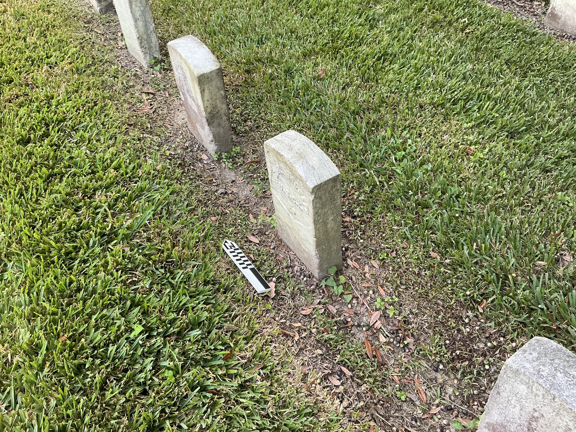 Extra image of historic upright marble headstone with recessed shield face.