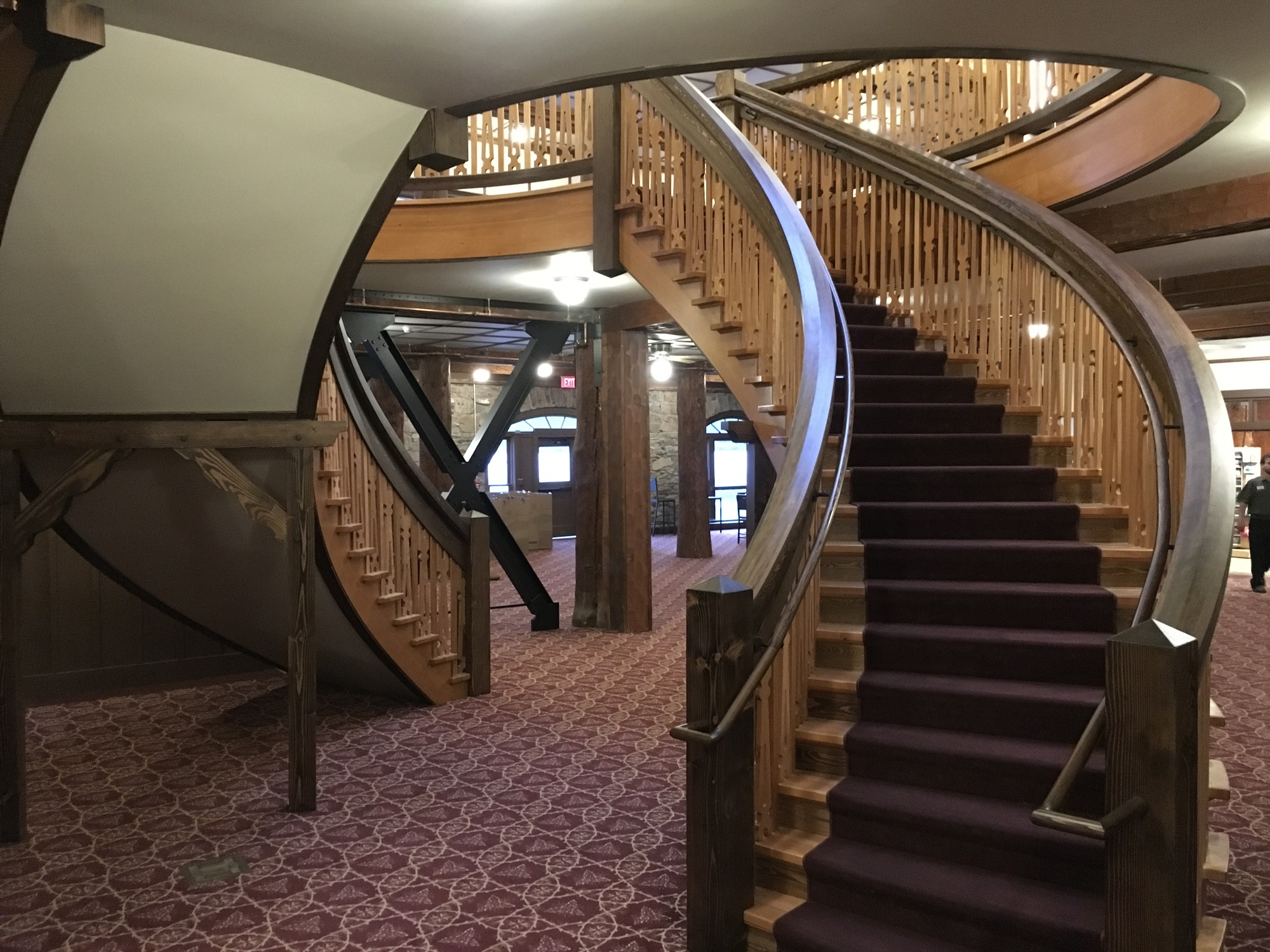 Two winding staircases inside a hotel lobby