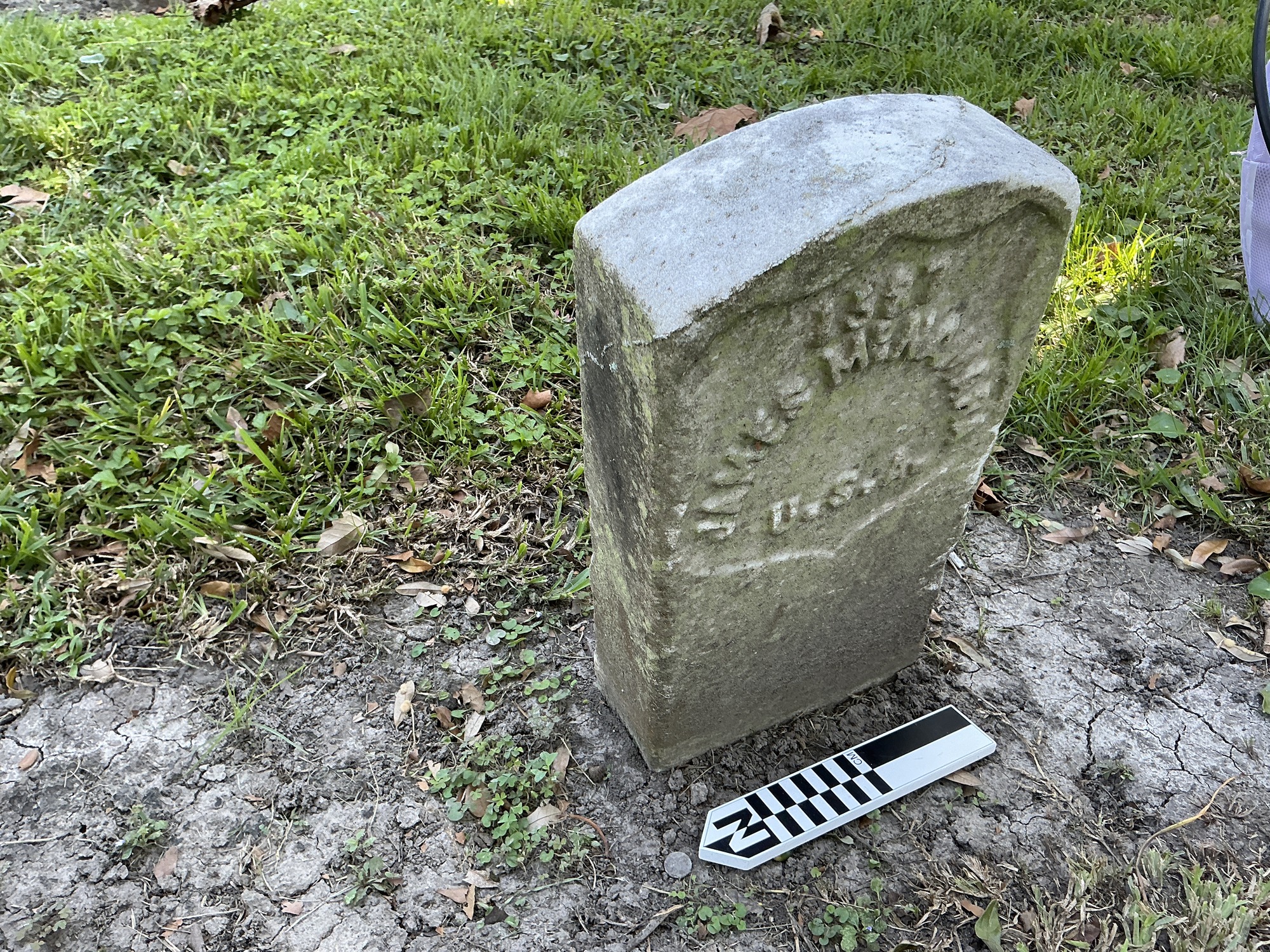Extra image of historic upright marble headstone with recessed shield face.