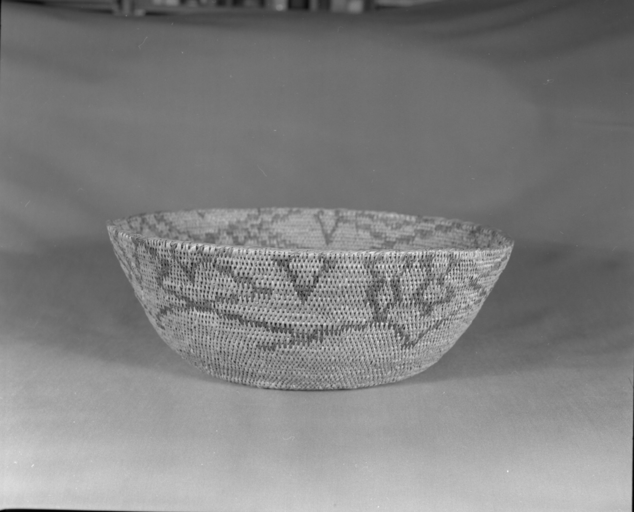 Private Collection. Object: Miwok basket. Dimensions: 13 x 4-3/4". Materials: Redbud and bull pine. Technology: Single rod, fag ends trimmed on work face, moving ends trimmed on interior. Leftward coil direction. Rim overstitched three times. Collection HIstory: Made by Matilda, a Sonora Miwok, c. 1920. Photographed by Michael Dixon. Catalogued by Craig Bates and Barbara Beroza. Yosemite Collections, National Park Service.