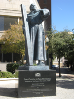 A statue of a man holding a cross.