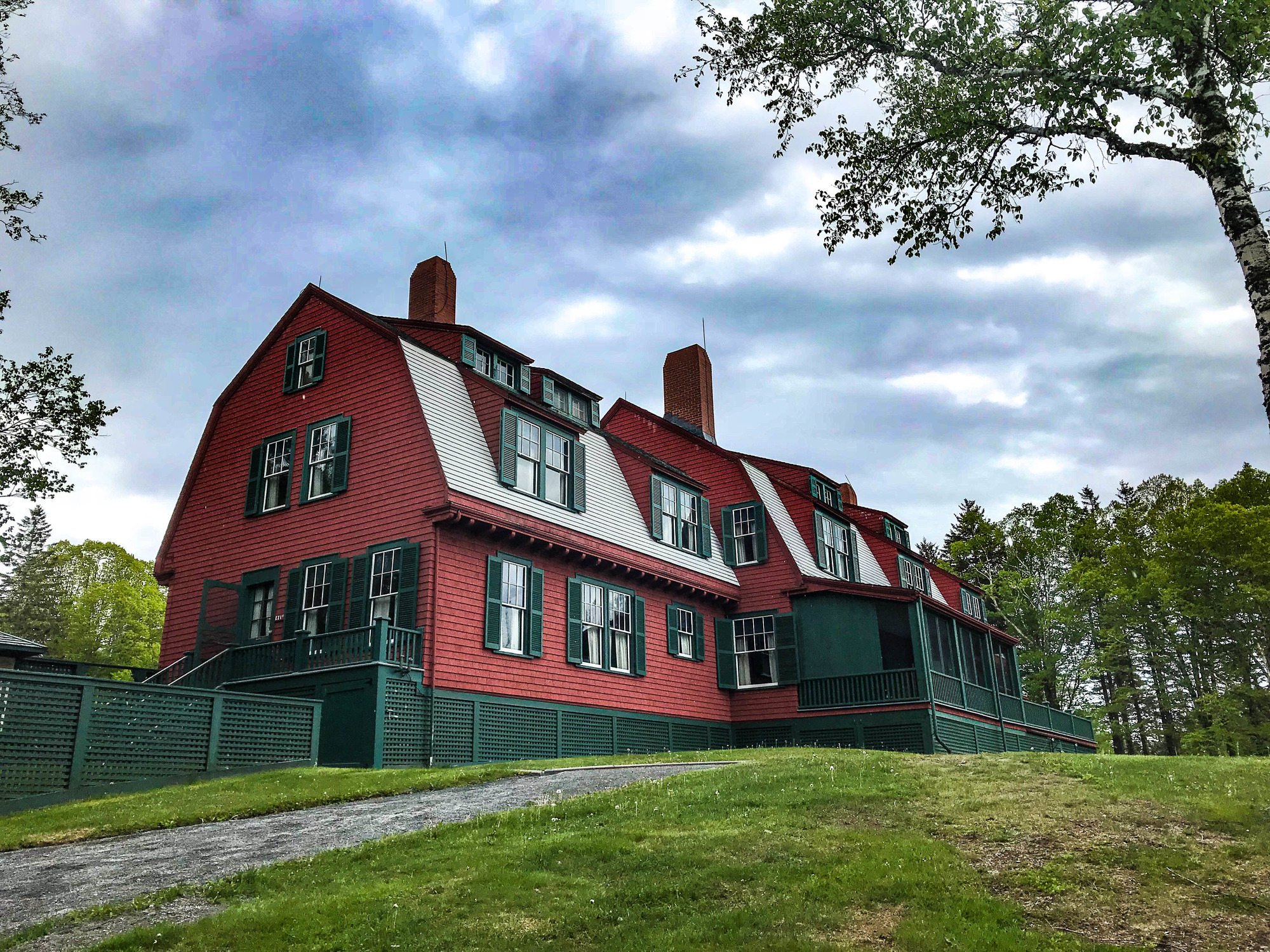 Red house with white and green roof and trim