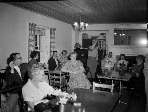 Men and women at Harry Brockmeier's retirement party in the ranger dormitory.
