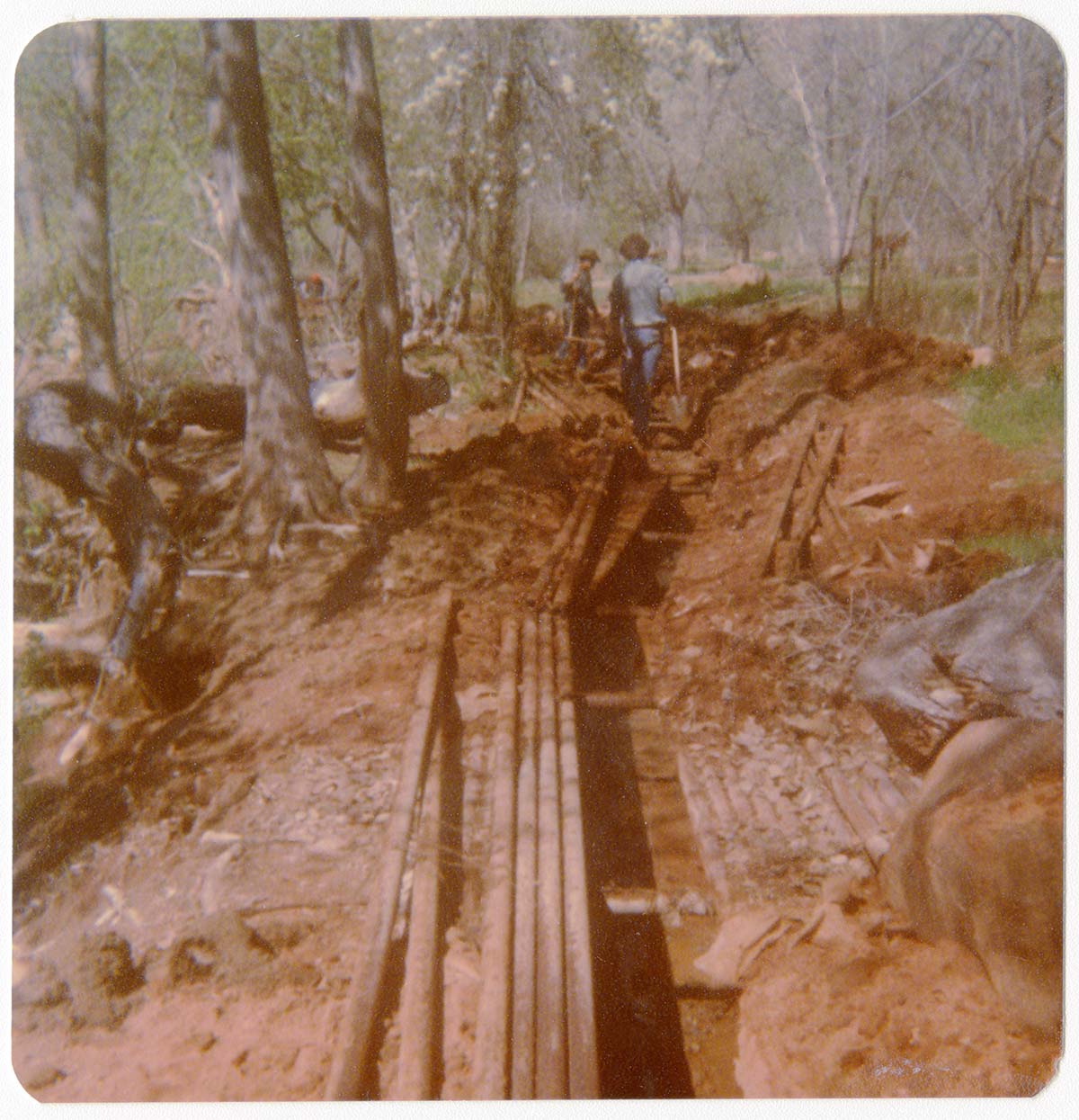 Workers uncovering the irrigation ditch in South Campground.