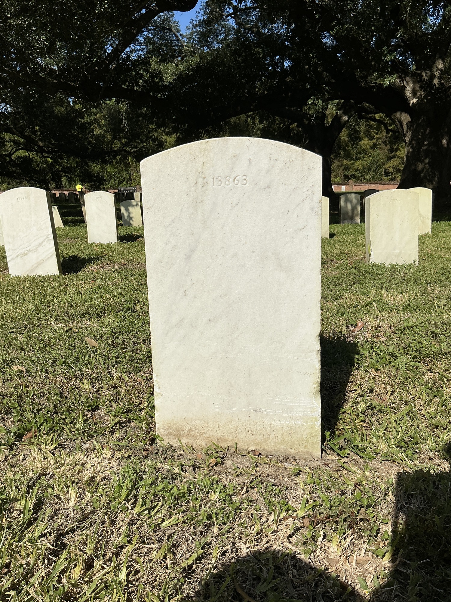 Back of upright marble headstone with flat face.