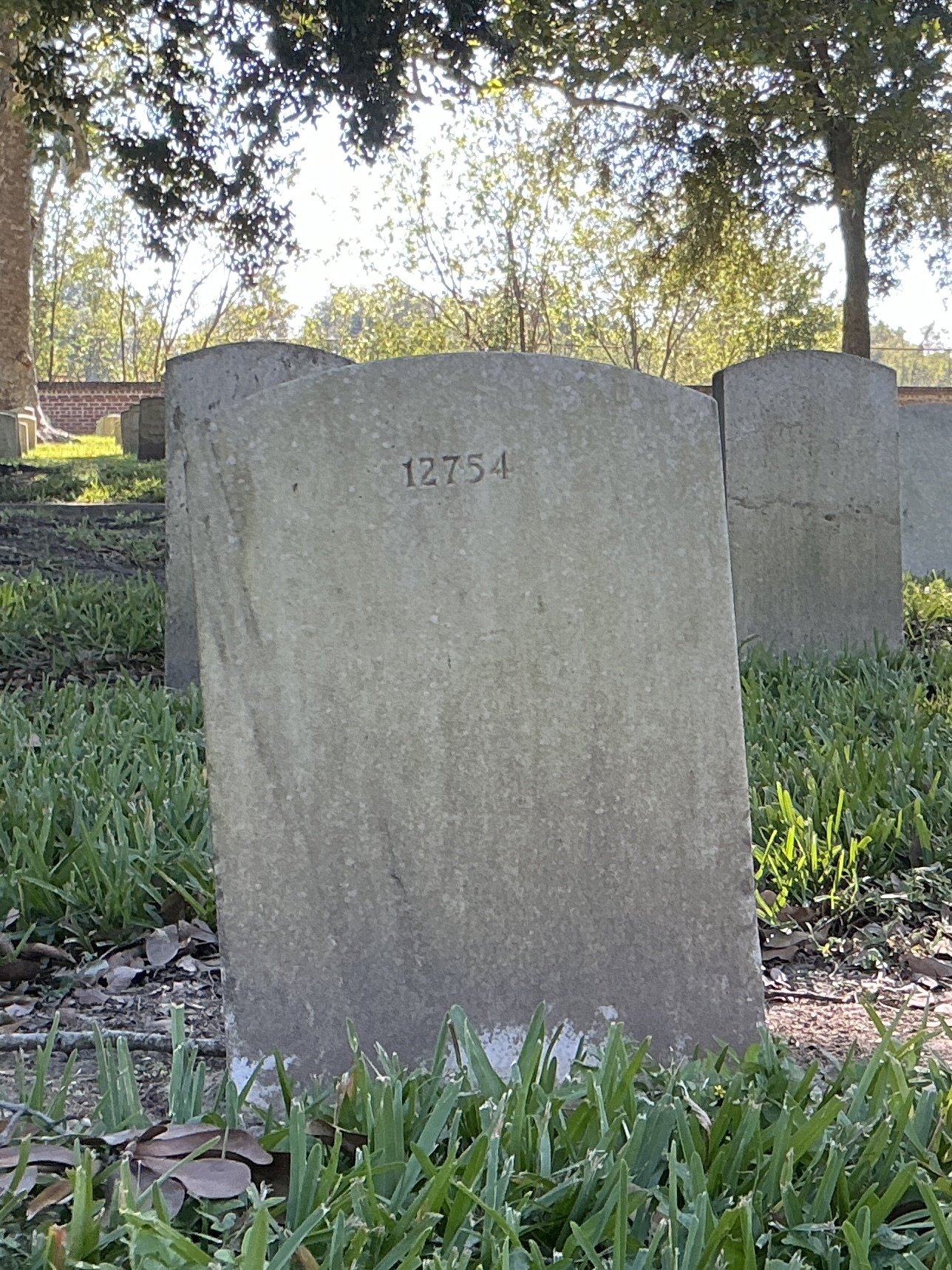 Back of upright marble headstone with flat face.