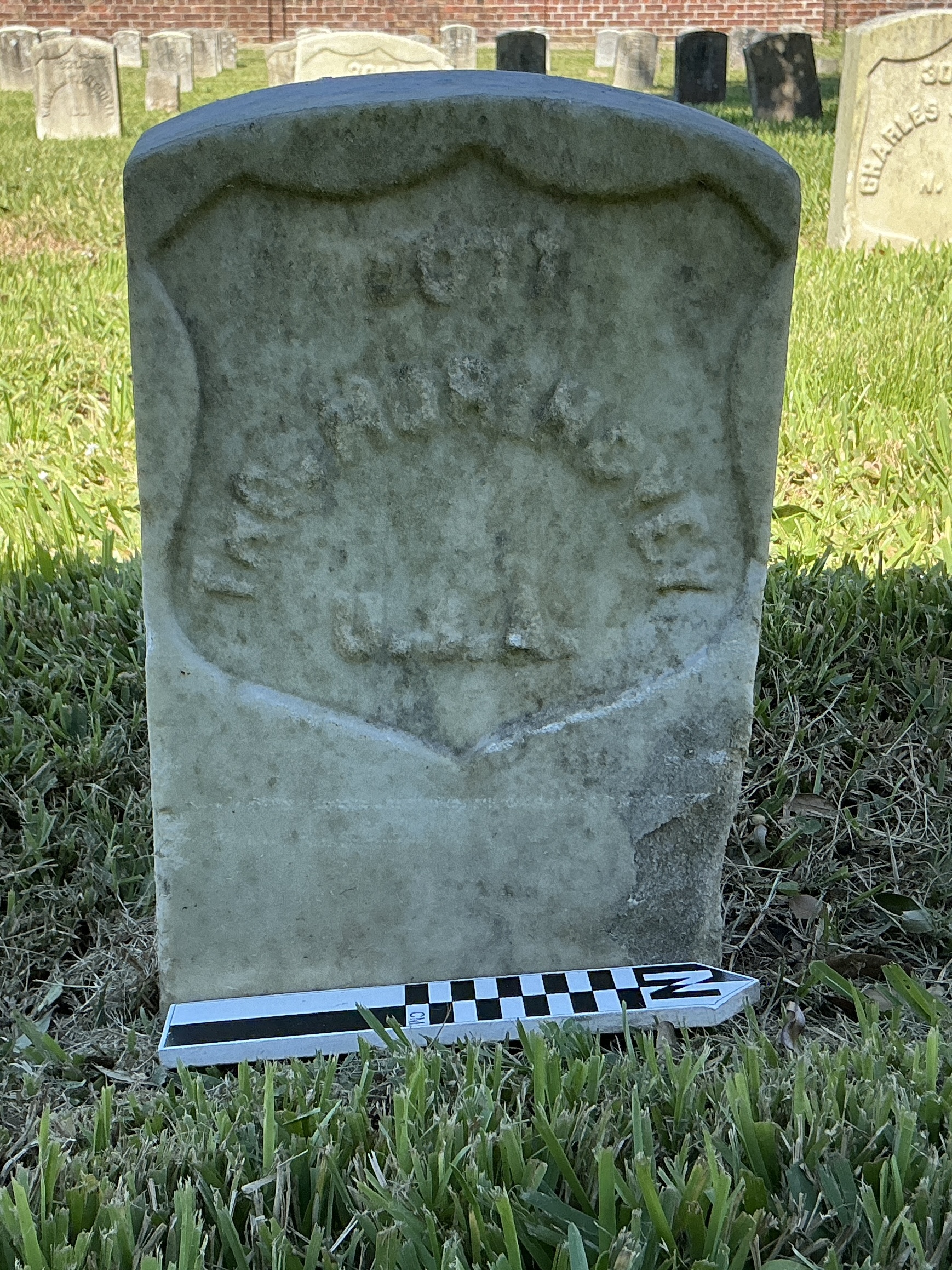 Extra image of historic upright marble headstone with recessed shield face.