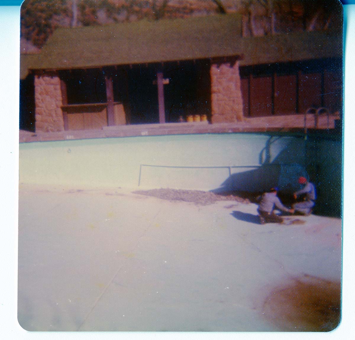 Workers preparing for the destruction of the lodge pool and bathhouse.