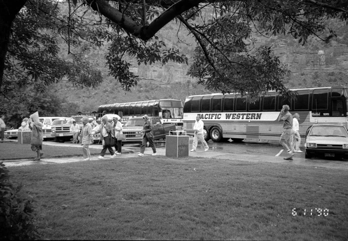 Visitors walking to and from their buses/vehicles to the headquarters building.