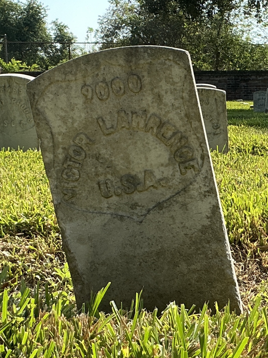 Front of historic upright marble headstone with recessed shield face.
