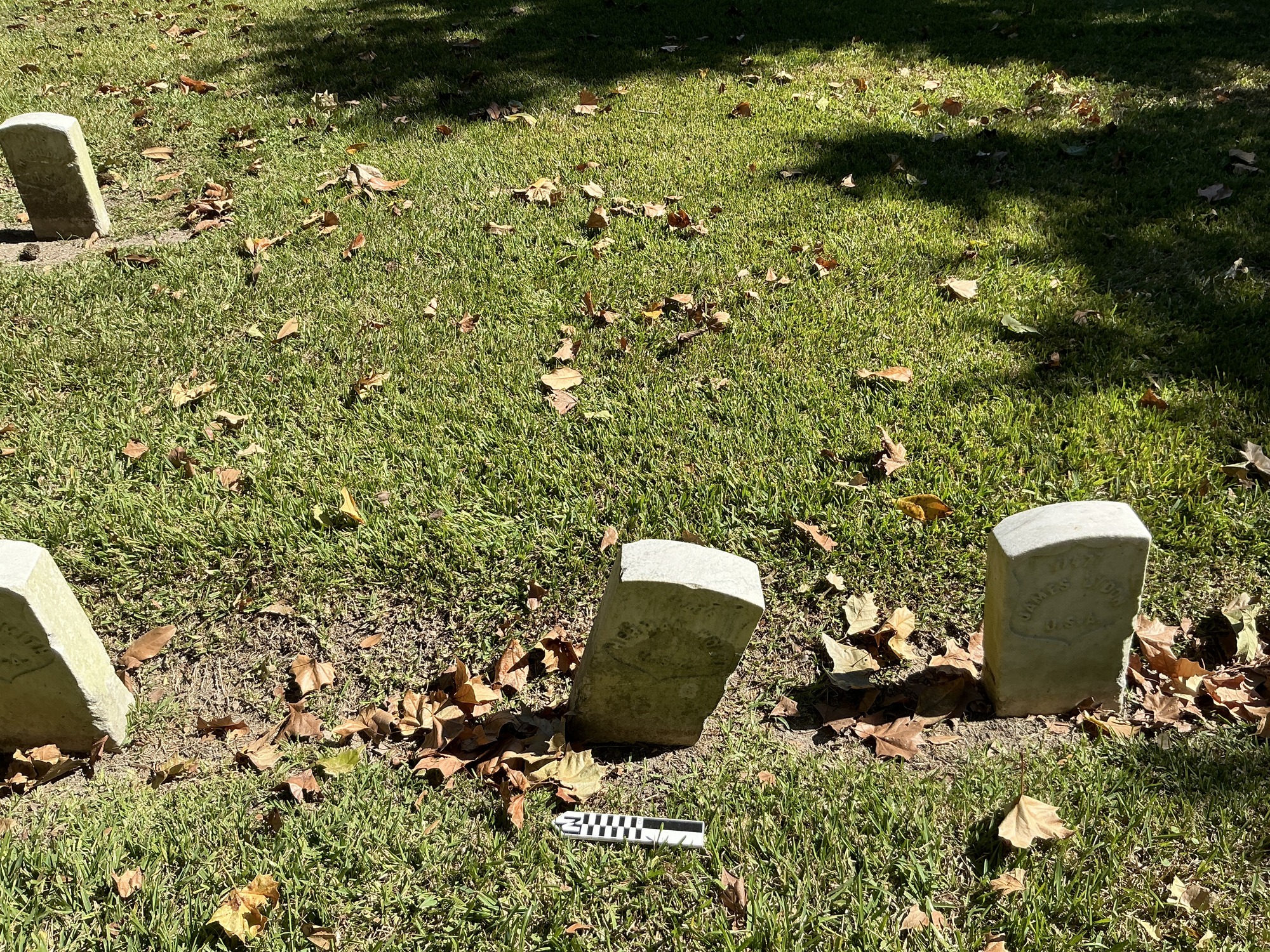 Extra image of historic upright marble headstone with recessed shield face.