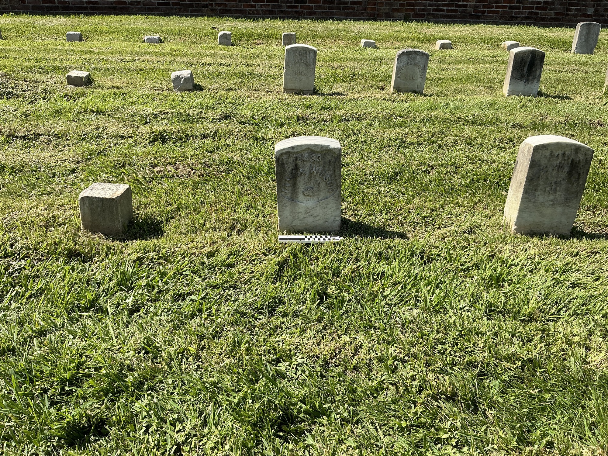 Extra image of historic upright marble headstone with recessed shield face.