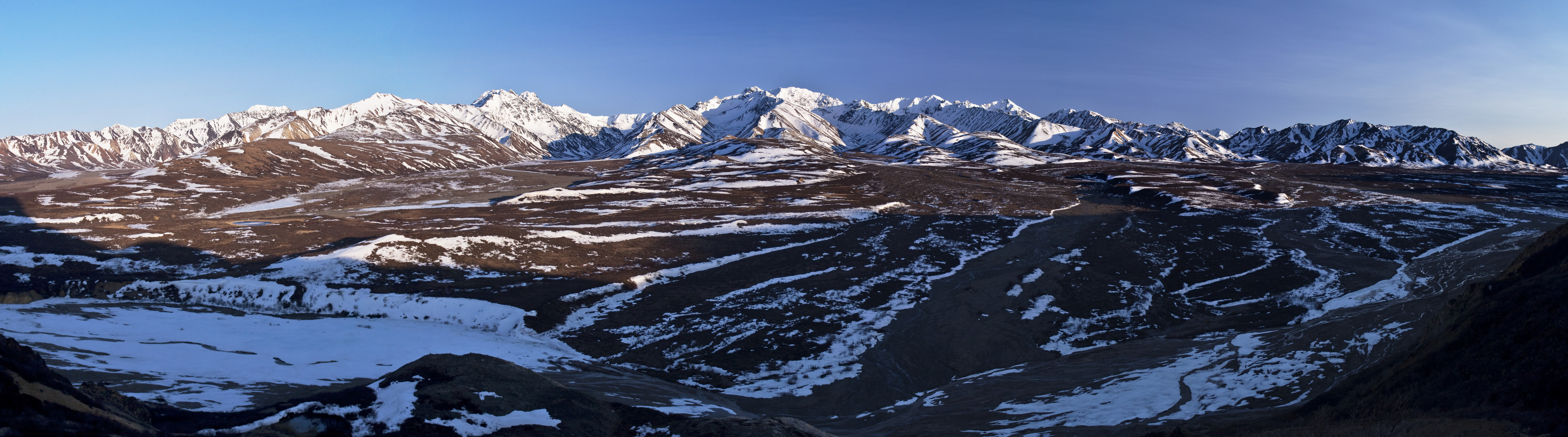 landscape of frozen rivers and snowy mountains