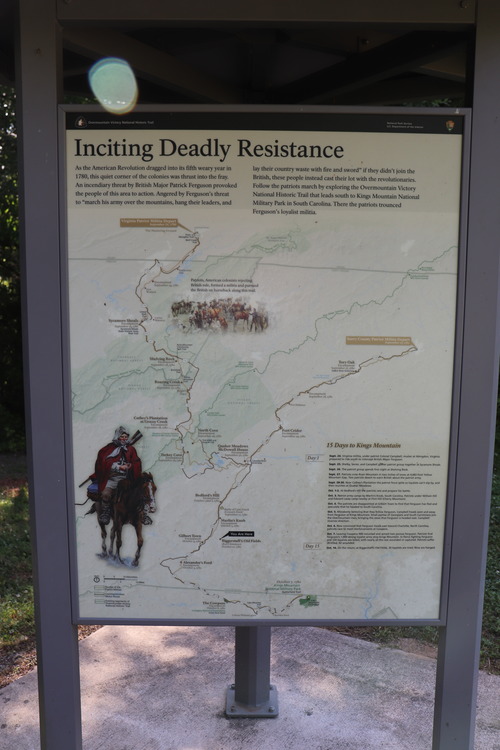 Sign with the title "Inciting Deadly Resistance." Sign contains a map with a squiggling line marking a historic trail, and a painting of a horseman wrapped in a blanket with a rifle slung across his back.