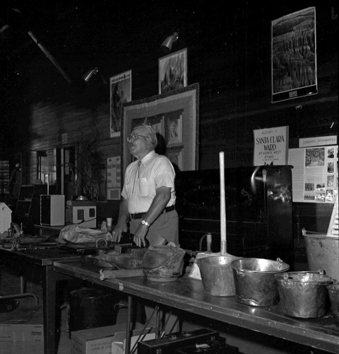 Owen Sanders behind folklife display of inventions, gadgets, and oddities from his collection of early pioneer days at the second annual Folklife Festival, Zion National Park Nature Center, September 7-8, 1978.