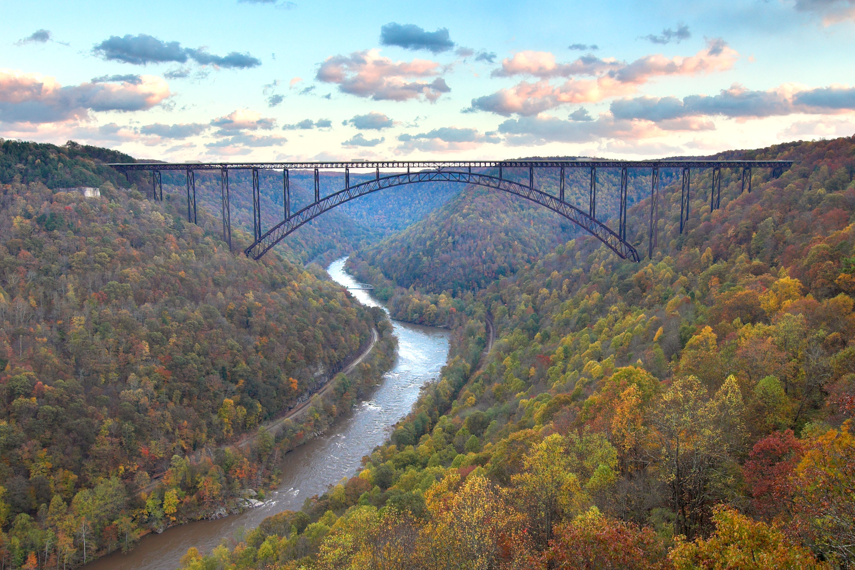 bridge spans a river and gorge with fall colors