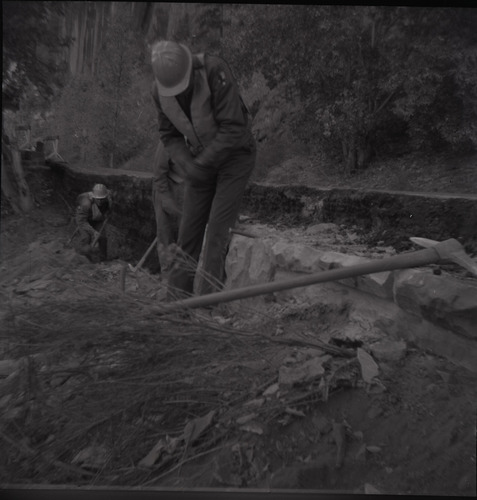 Men working on rebuilding the rock retaining wall alongside road at Zion-Mt. Carmel Highway tunnel.