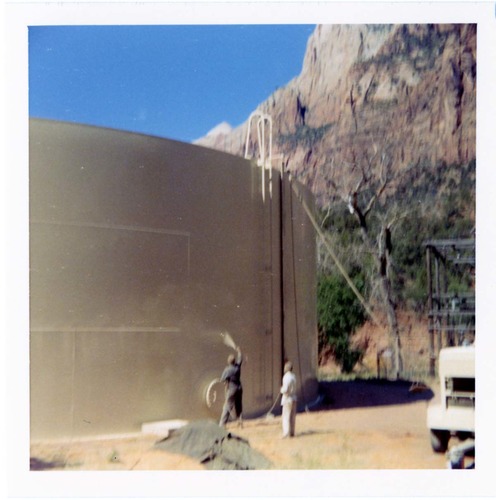 Workers repainting the exterior of the million gallon water tank at Birch Creek.