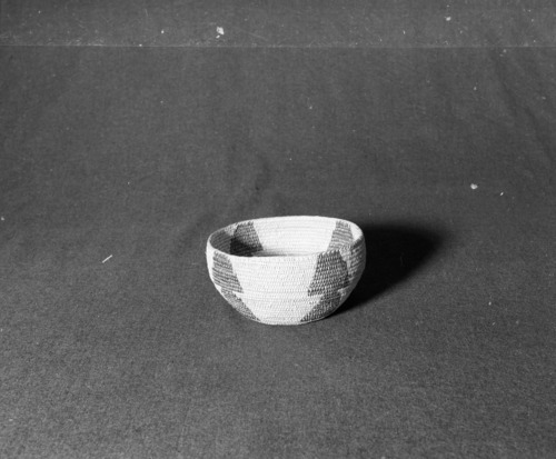 Marie Rozier Collection, Catalog No. 65. Object: Miwok basket. Dimensions: 6 1/2 x 3 1/2". Materials: Split willow, split redbud, tree-rod willow. Technology: Leftward coil direction, fag ends trimmed or flipped, moving ends trimmed on interior. Collection History: This was the last basket made by Mrs. Louise Fuentes when she was eighty years old. She died in January 1959 at the age of eighty-three. Photographed by Michael Dixon in December 1982. Catalogued by Craig Bates and Barbara Beroza. Yosemite Collections, National Park Service.
