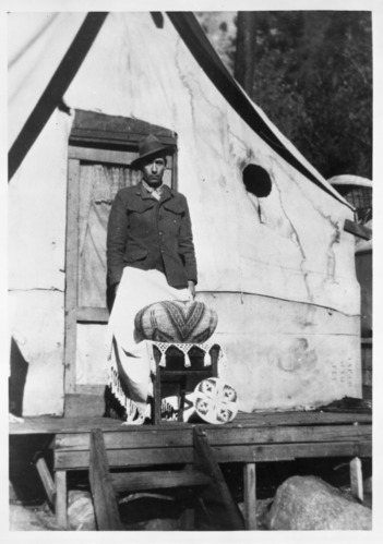 John Telles with basket by Lucy Telles. Native American Village, Yosemite.