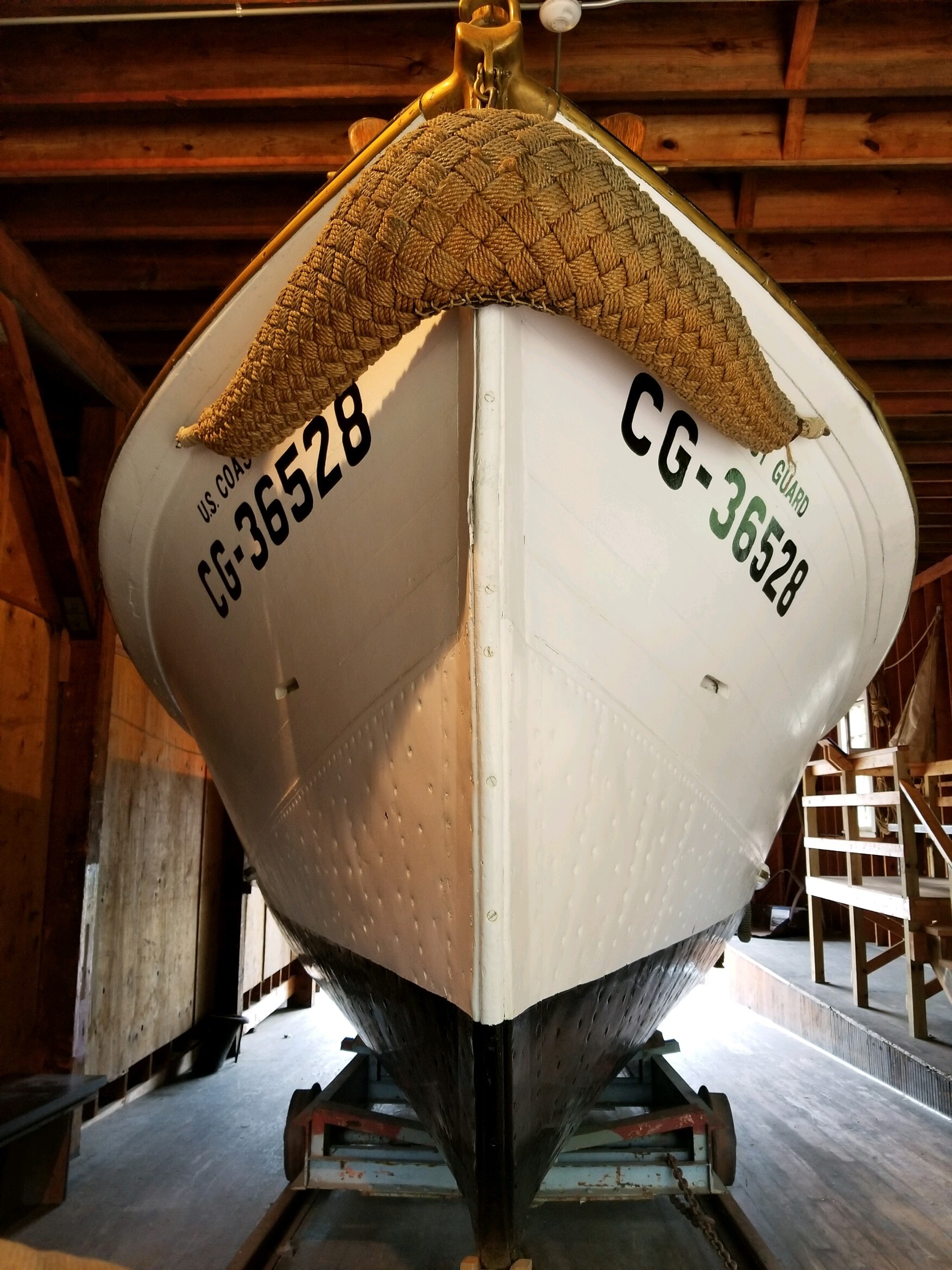 The bow of the boat with a rope fender (bumper) on the nose. Written on either side: US Coast Guard CG-36528
