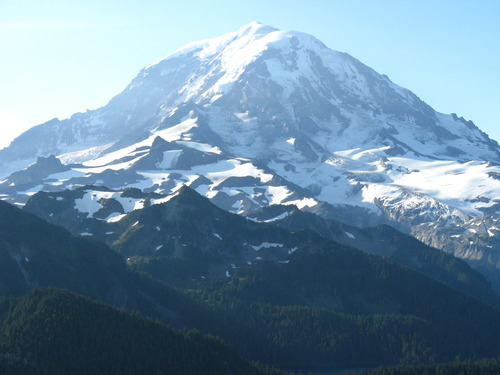 A glaciated mountain peak with rocky ridges and cliffs. 