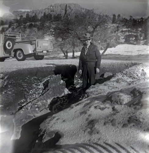 Man inspecting road work progressing along the scenic canyon drive near the Grotto.
