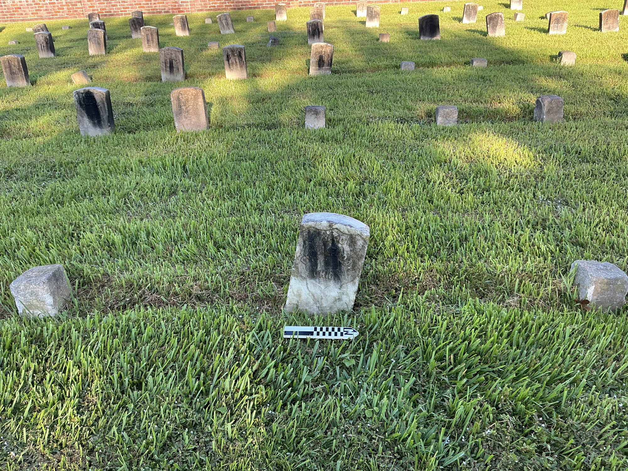 Extra image of historic upright marble headstone with recessed shield face.