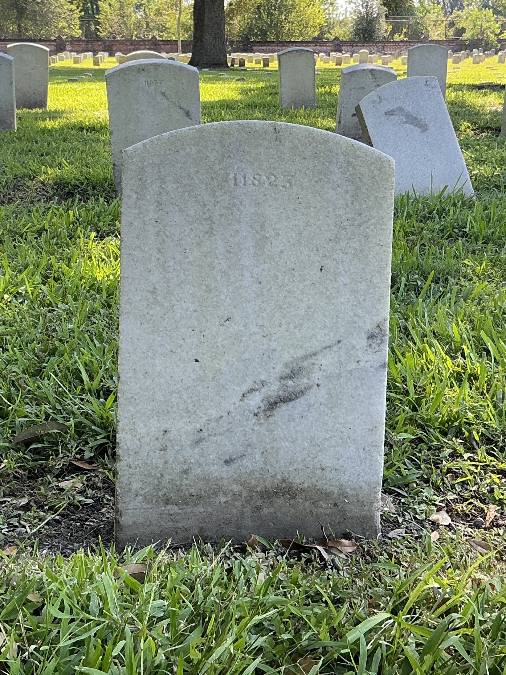 Back of upright marble headstone with flat face.
