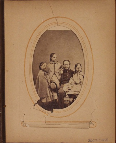 Black and white photograph of man and three young girls.