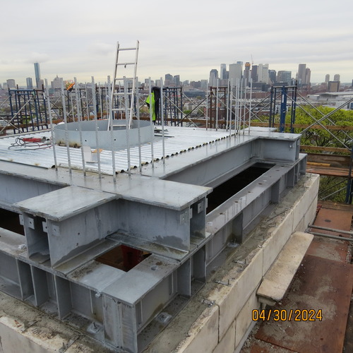 Structural steel installed on top of a marble tower. 