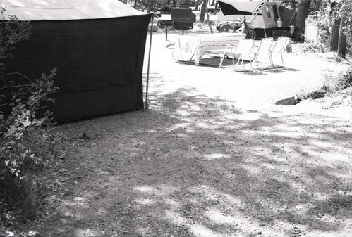 Tent, tables, and chairs set up in a campsite in South Campground.