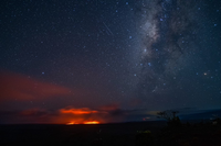 Milky Way and a red glow observed from a distance. 