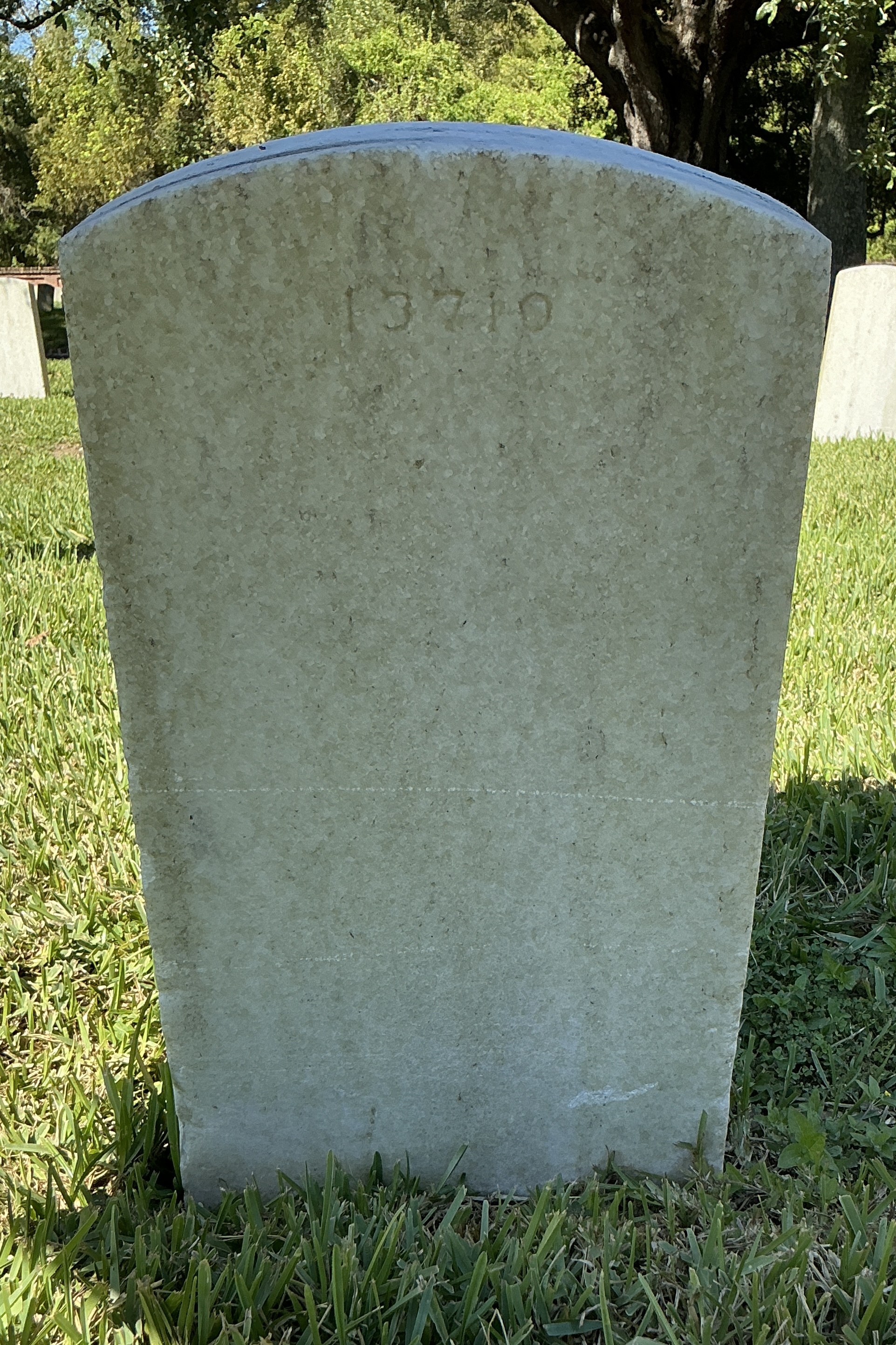 Back of upright marble headstone with flat face.