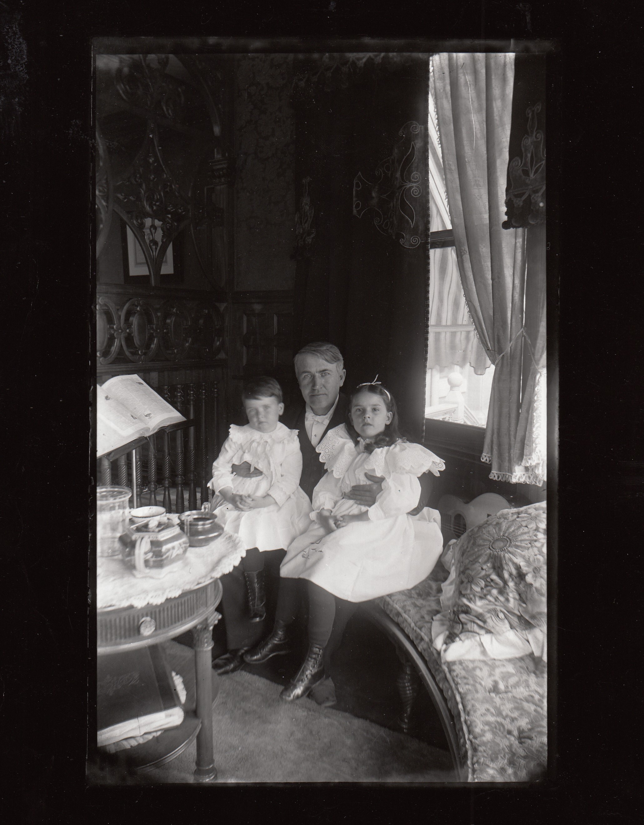 Thomas Edison at Glenmont, with Charles Edison and Madeleine Edison seated on his lap.