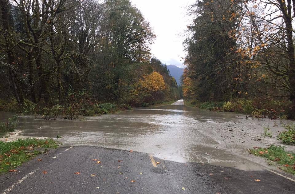 Water flows across a section of roadway