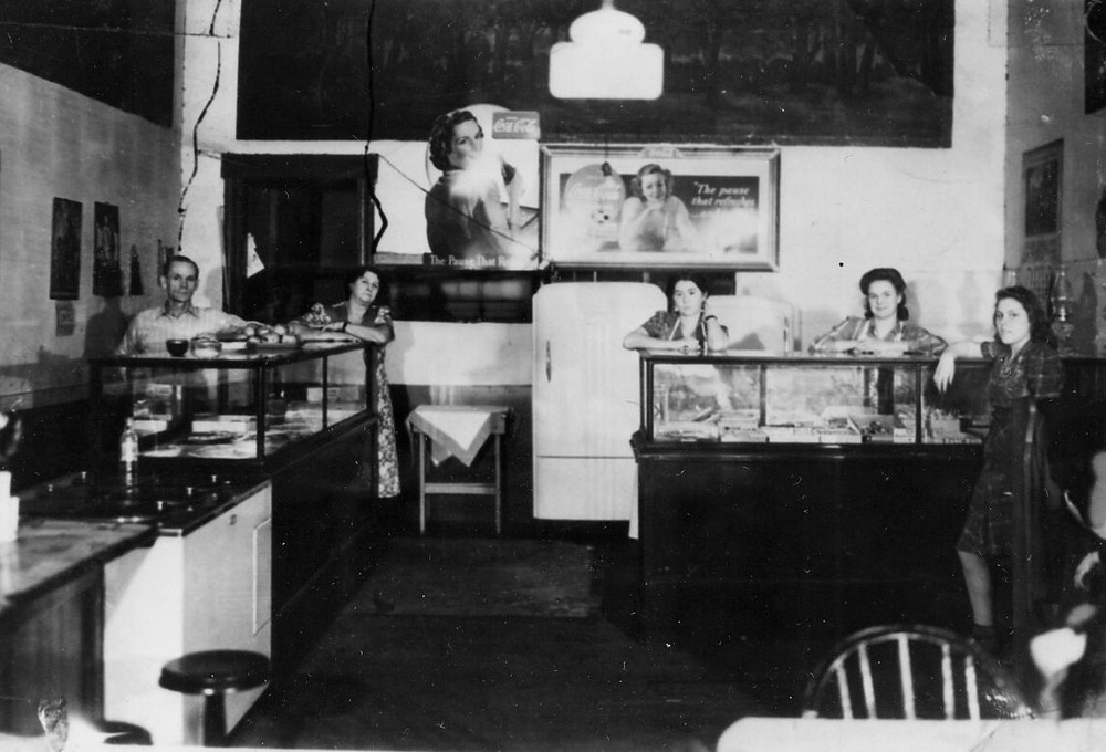 historic photo of people behind a counter in a restaurant