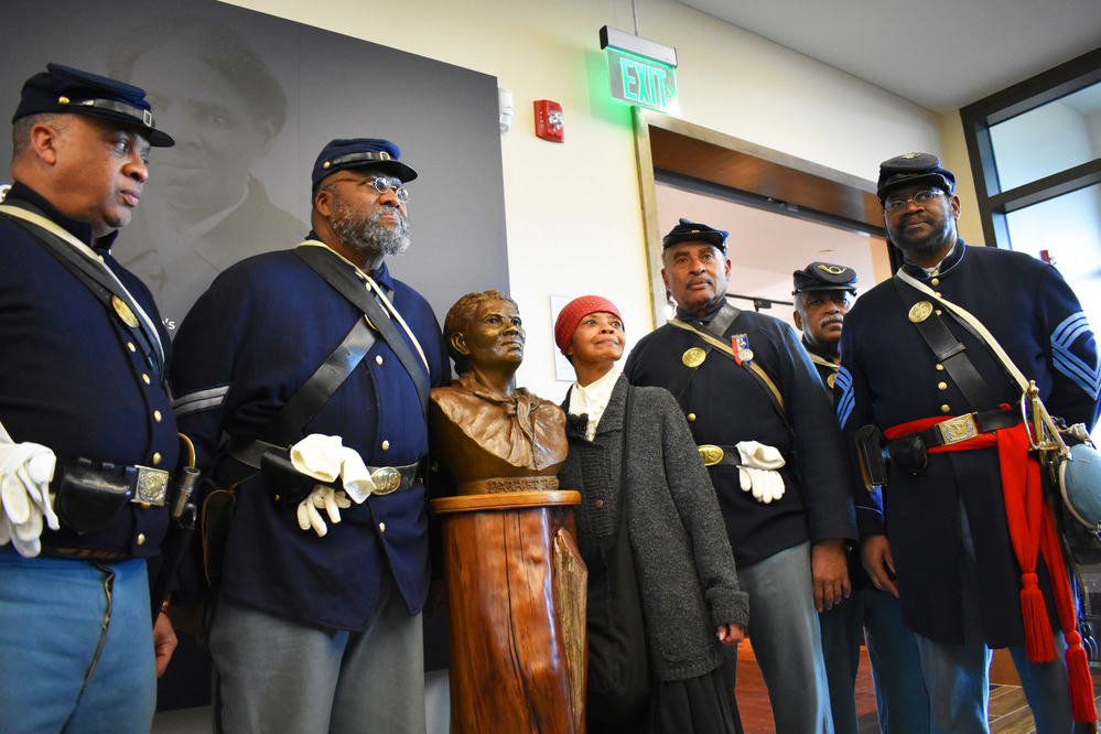 Civil War re-enactors pose next to Tubman Bust inside the Visitor Center.