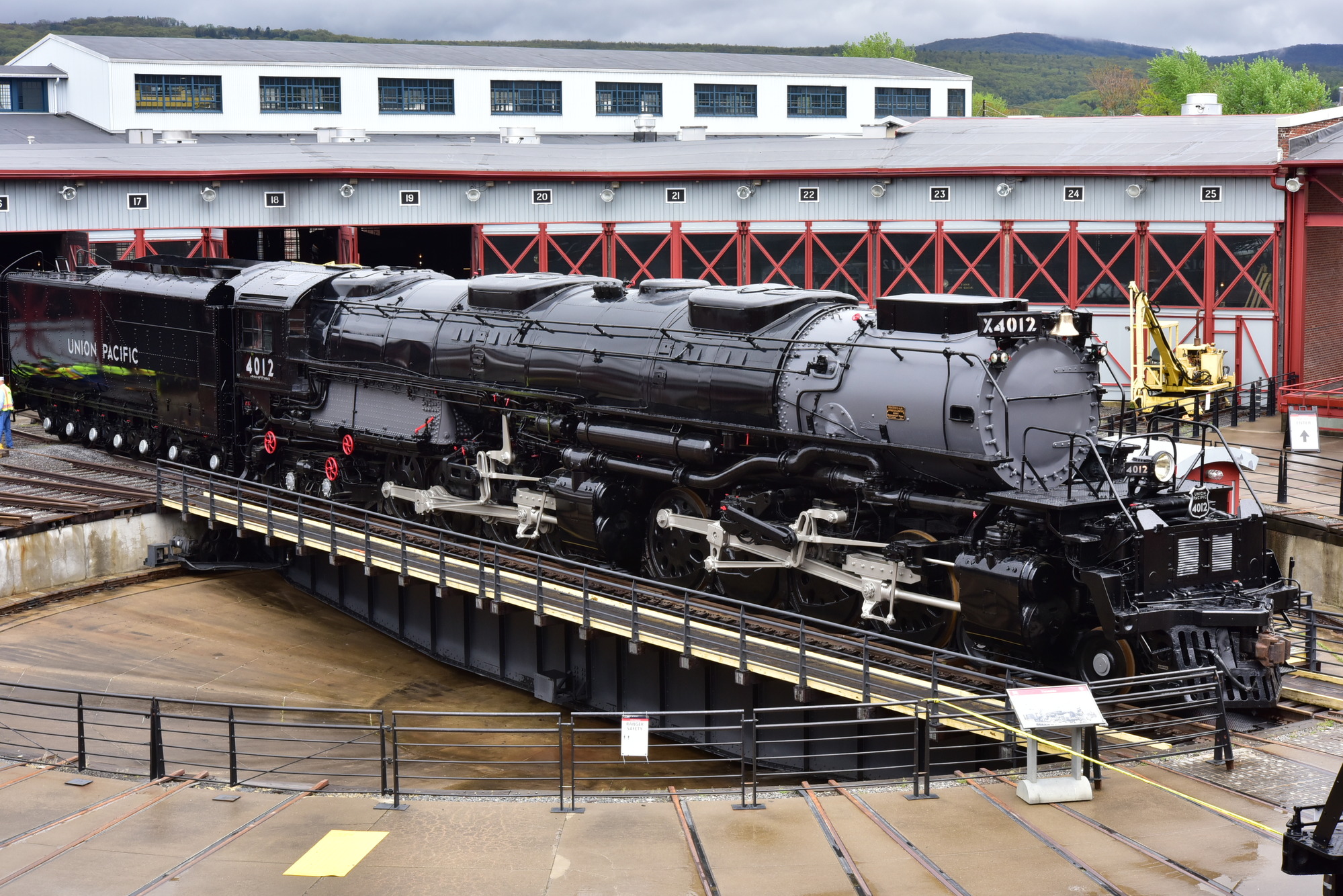 Elevated viewpoint of a large black train on a turntable track