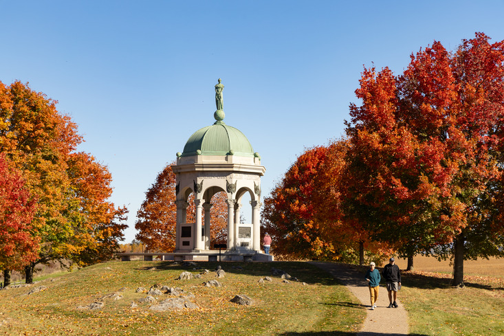 A monument surrounded by red trees