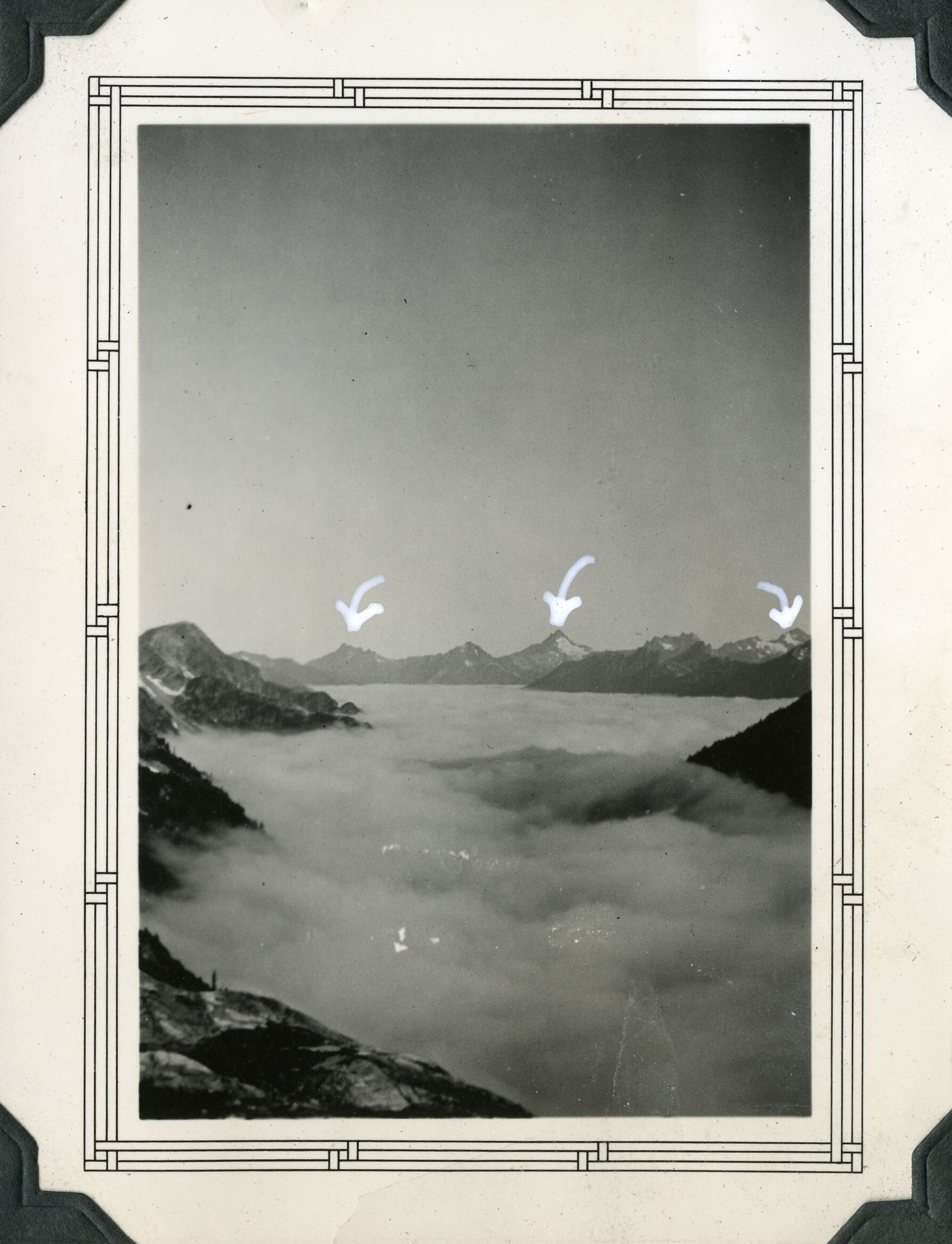 Distant mountain peaks with heavy fog layer between them.