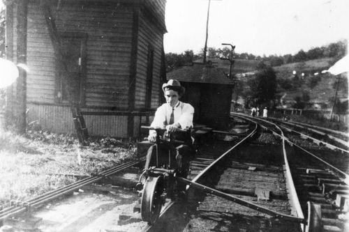 historic photo of man on rail cycle