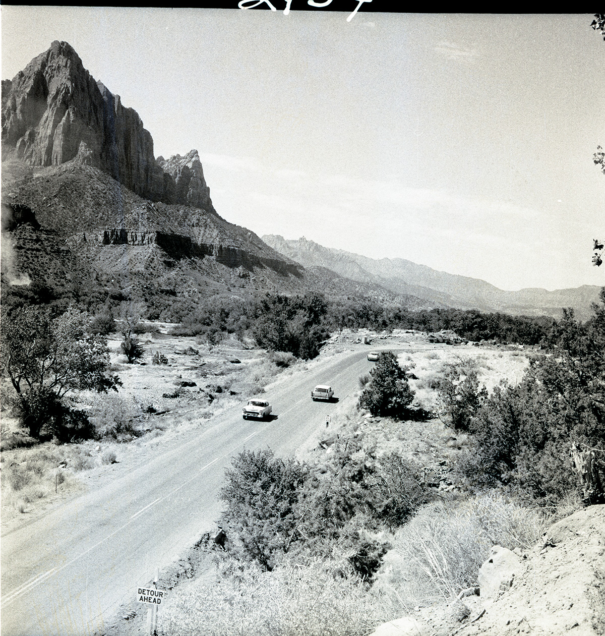 Traffic on old highway (State Route 9), detour sign on bottom left advises motorists of road construction.