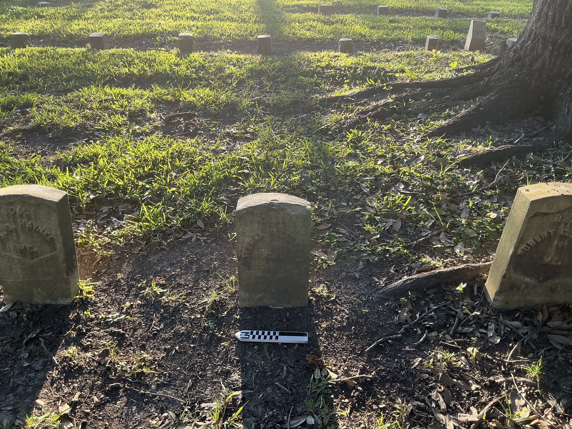 Extra image of historic upright marble headstone with recessed shield face.