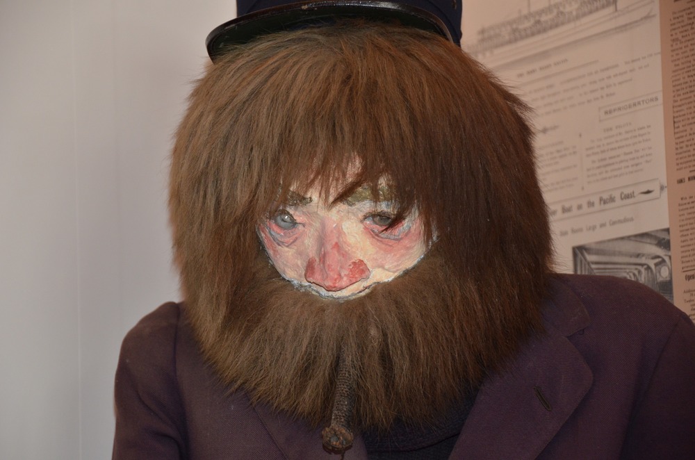 A bearded manikin seated in a corner